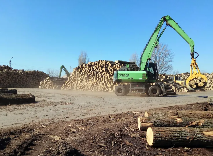 Machine clearing timber off a wooded lot